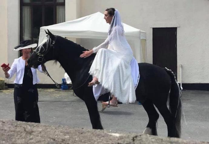 Bride arriving at church on a horse